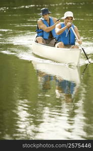 Two mid adult men boating in a lake