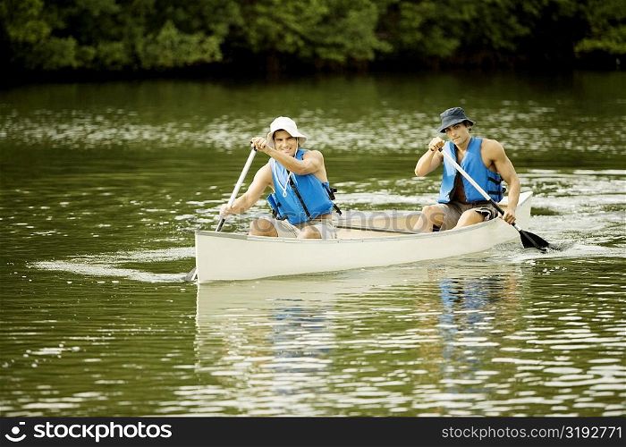Two mid adult men boating in a lake