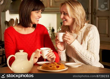 Two Middle Aged Women Enjoying Tea And Cake Together