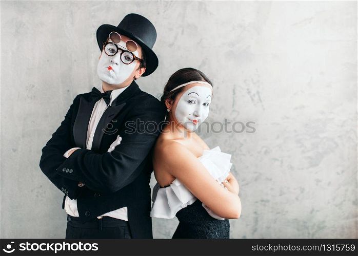 Two mime actors performing in studio. Pantomime theater artists with white makeup masks on faces