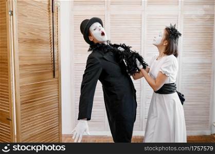 Two mime artists, love couple parody. Pantomime theater, comedian, positive emotion, humour performance, funny face mimic and grimace. Two mime artists, love couple parody
