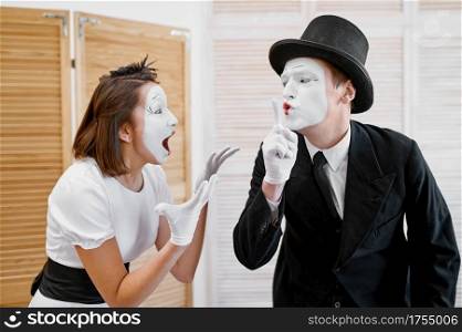 Two mime artists, secret lovers parody. Pantomime theater, comedian, positive emotion, humour performance, funny face mimic and grimace. Two mime artists, secret lovers parody