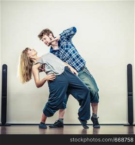 Two modern dancers couple woman and man dancing. Urban lifestyle. Hip-hop generation.