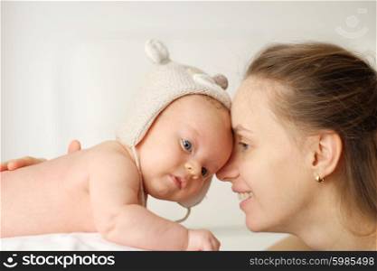 Two months old newborn baby with his mother