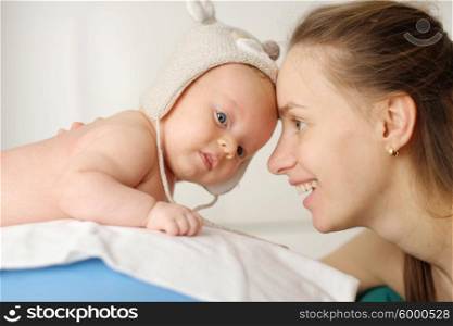 Two months old newborn baby with his mother