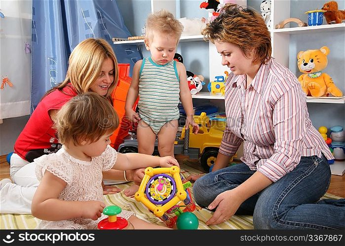 two mothers and children in playroom