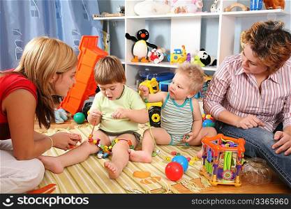 two mothers play with children in playroom 2