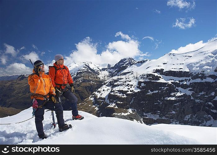 Two mountain climbers on snowy peak