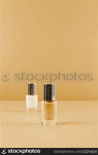 two nail polish bottles abstract brown background