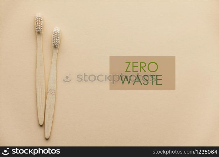 Two natural wooden toothbrushes on color background, flat lay, top view. Concept of zero waste and dental care. Copyspace