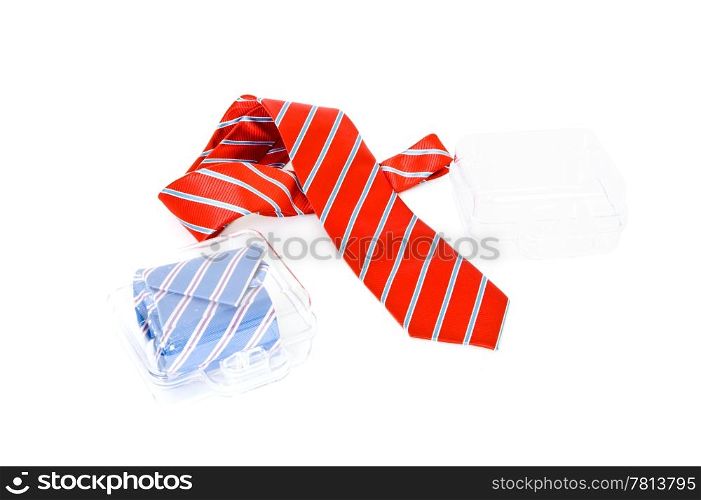 Two neckties, one in a gift box, one casually draped besides an empty case