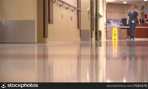Two nurses walk down the hall in a modern hospital