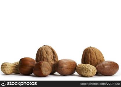 two of each pecan hazelnuts walnuts and peanuts. two of each pecan hazelnuts walnuts and peanuts on white background