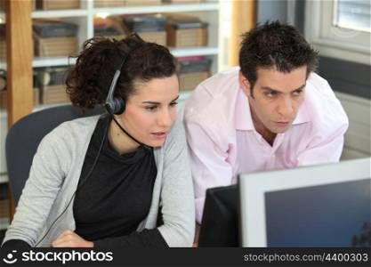 two office colleagues looking at a screen