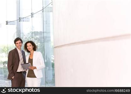 two office workers standing