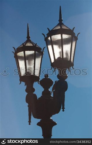 two old lanterns against the blue sky