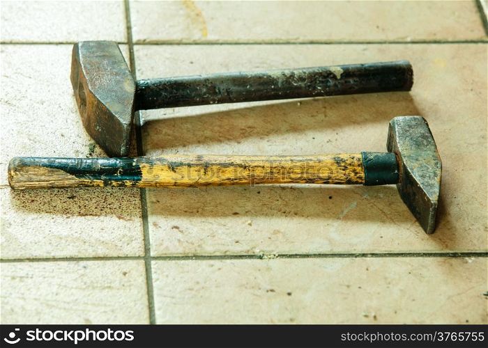 Two old metal sledge hammers hand tools in mechanic garage car service