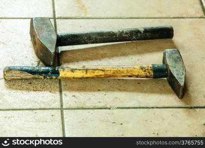 Two old metal sledge hammers hand tools in mechanic garage car service