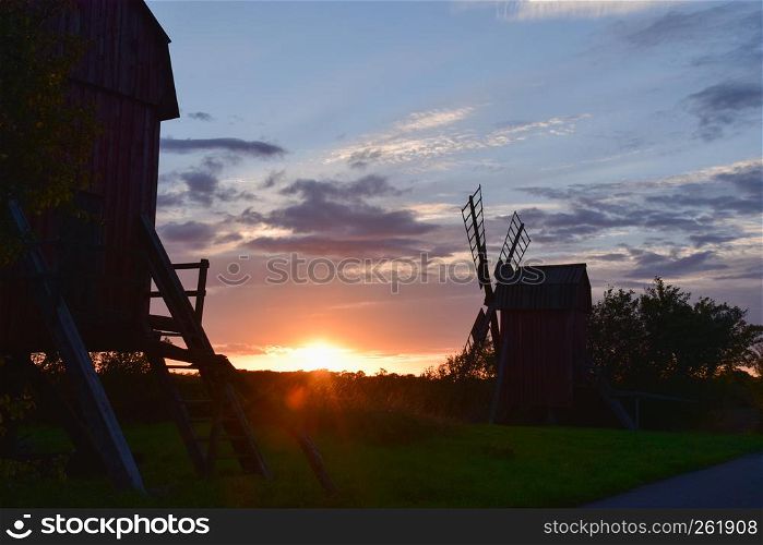 Two old windmills by sunset at the swedish island Oland in the Baltic Sea