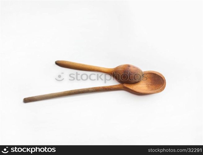 Two old wooden spoons isolated on white background. Two wooden spoons isolated on white background