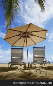Two outdoor chairs and a beach umbrella on the beach, Ocean Park, El Condado, San Juan, Puerto Rico