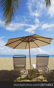 Two outdoor chairs and a beach umbrella on the beach, Ocean Park, El Condado, San Juan, Puerto Rico