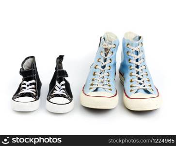 two pairs of textile sneakers with white laces on a white background, shoes of a child and an adult
