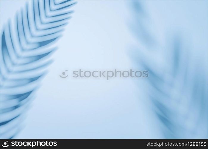 Two palm fronds casting shadows on a wall with copy space as a design template or tropical background in a full frame view. Border arrangement