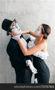 Two pantomime theater artists performing. Mime actors with white makeup masks on faces