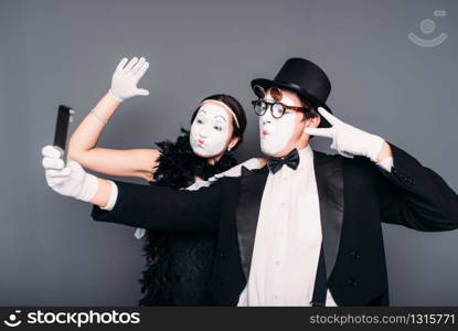 Two pantomime theater performers makes selfie on camera. Mime actor and actress performing. Comedy artistes