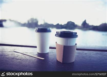 Two paper cups by the lake in winter