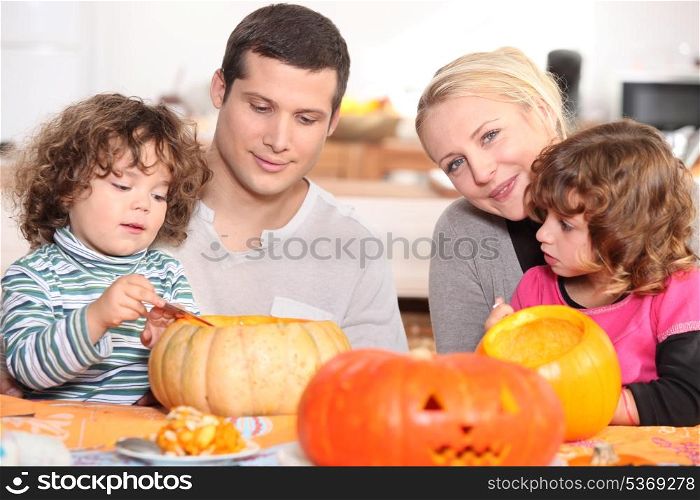 two parents and their two children celebrating Halloween