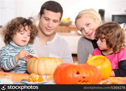 two parents and their two children celebrating Halloween
