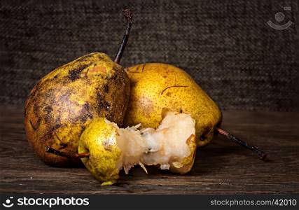 Two pears and stub on wooden table background sacking