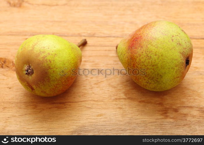 Two pears fruits on old wooden table background. Healthy food organic nutrition