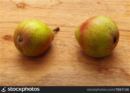 Two pears fruits on old wooden table background. Healthy food organic nutrition