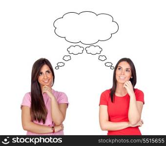 Two pensive brunette girls isolated on a over red background