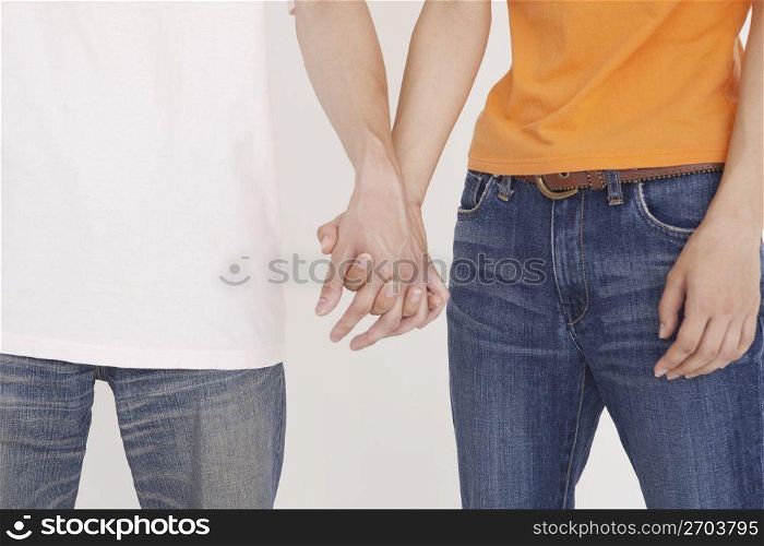 two people hold hands