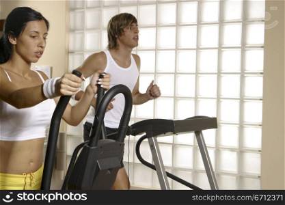 Two people on exercise bikes