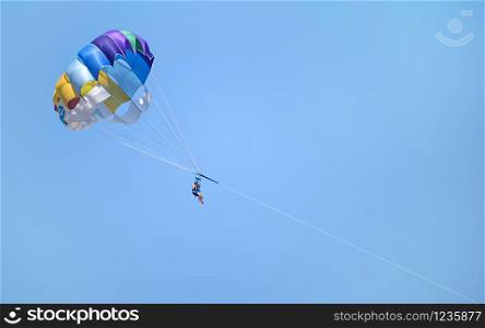 Two people parasailing parascending in Spanish coasts