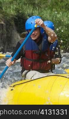 Two people rafting in a river