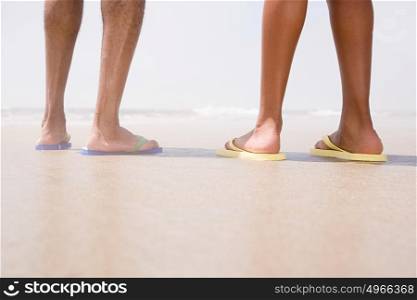 Two people standing on a beach