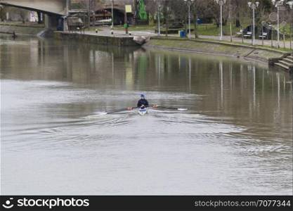 Two people training in a canoe on a river