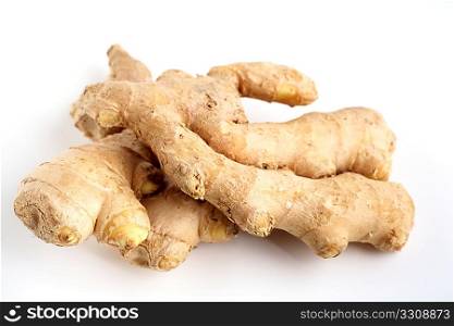 Two pieces of fresh root ginger viewed from the side against a white background