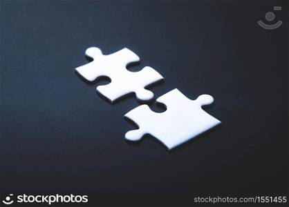 Two pieces of jigsaw puzzle or autism puzzle piece symbol, business partner concept