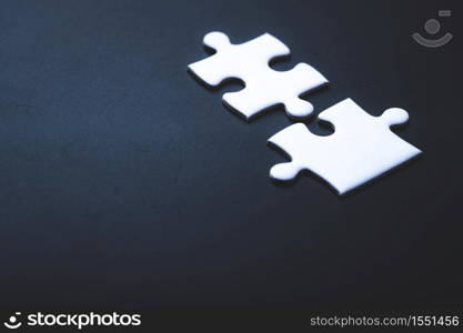 Two pieces of jigsaw puzzle or autism puzzle piece symbol, business partner concept
