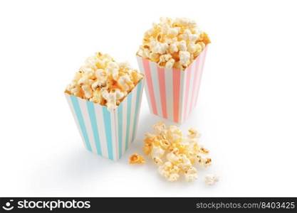 Two pink and blue striped carton buckets with tasty cheese popcorn, isolated on white background. Movies, cinema and entertainment concept.