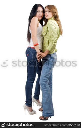 Two playful beauty young women in jeans. Isolated
