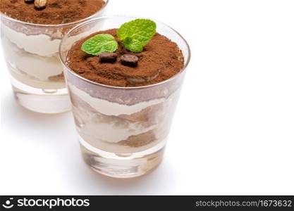 two portions Classic italian tiramisu dessert in a glass isolated on a white background with clipping path. two portions Classic tiramisu dessert in a glass isolated on a white background with clipping path