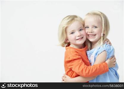 Two Pre School Girls Hugging One Another